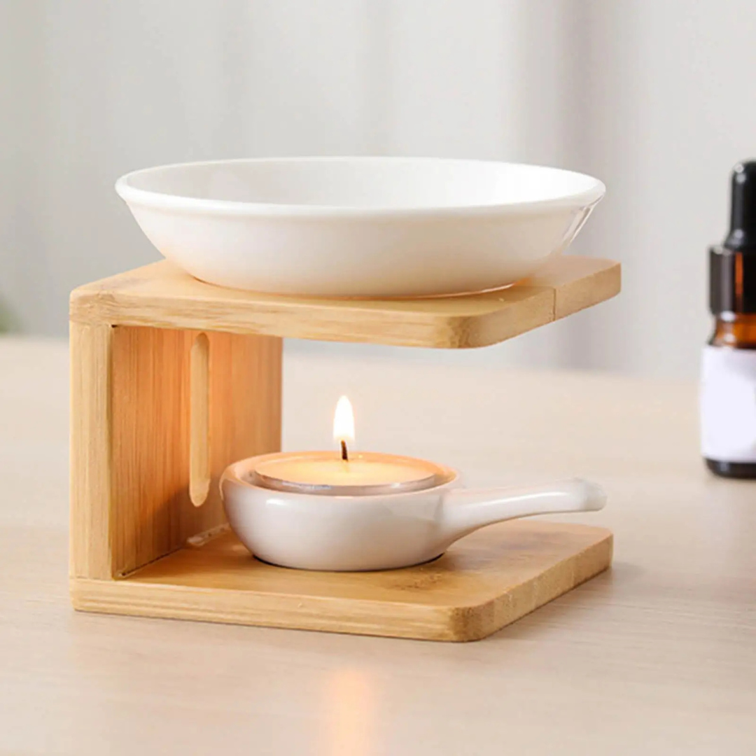 Ceramic bowl on a wooden stand with a lit candle inside, on a neutral background.