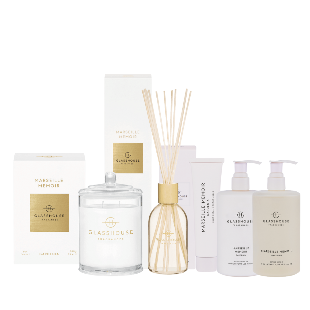 Collection of Glasshouse Fragrances products including a candle, diffuser, and bottles on a white background.