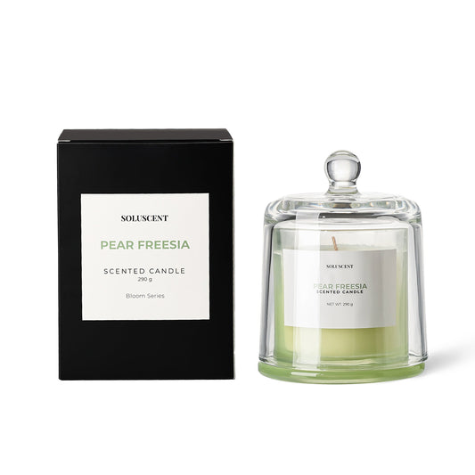 Soluscent Pear Freesia candle in reusable glass vessel beside presentation box
