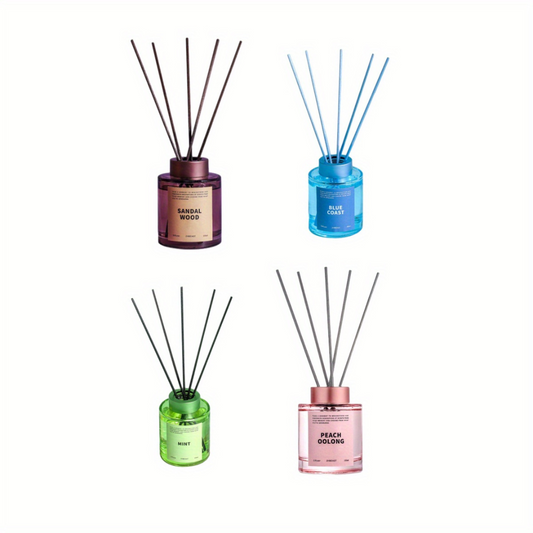 Four diffusers with different colored bottles and labels on a white background
