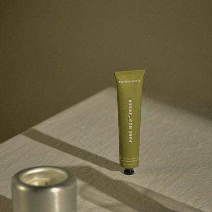 Addition Studio Blue Gum and Lemon Myrtle Hand Cream 100mL styled on linen beside a candle