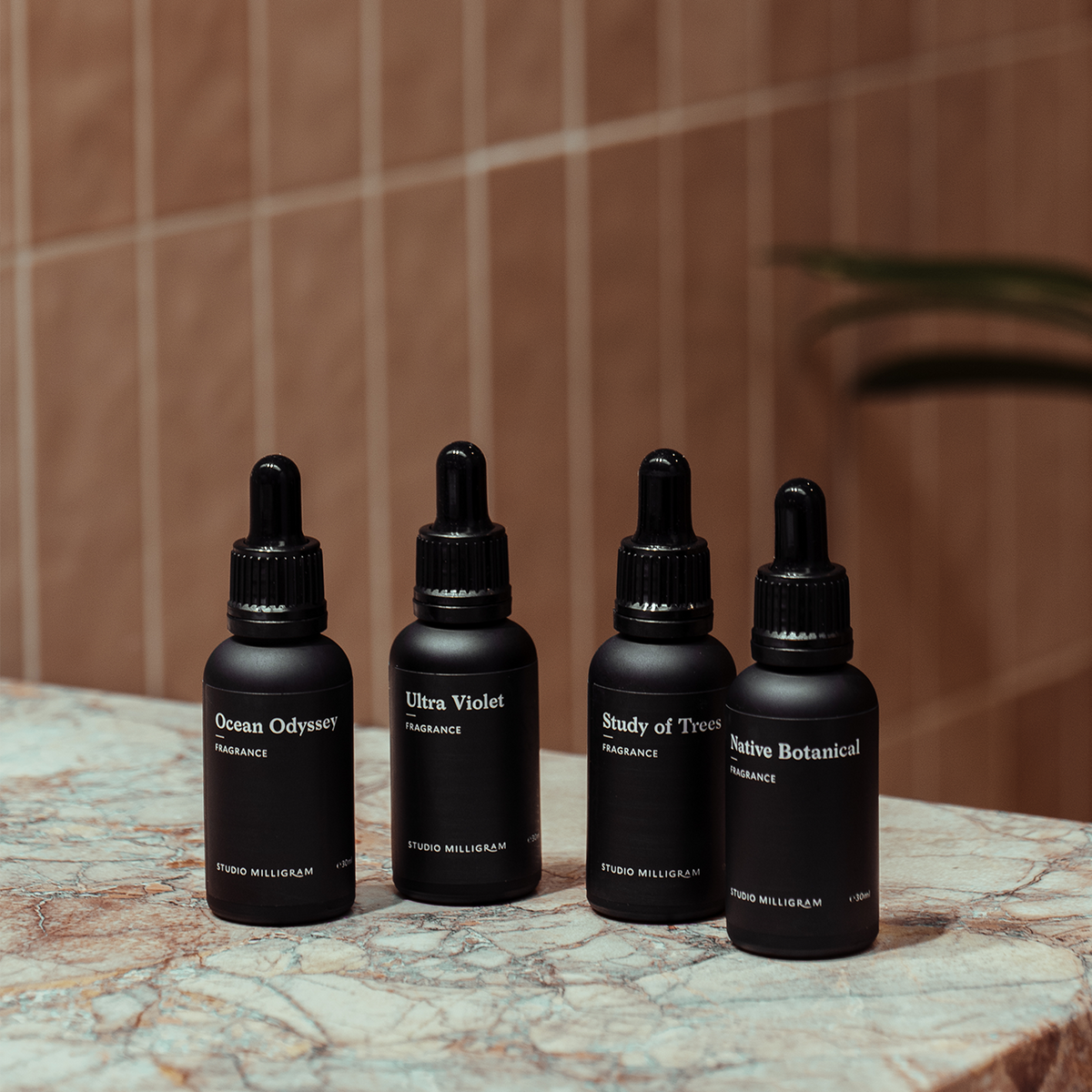 Studio Milligram Study of Trees fragrance top-up photographed with original black brand dropper bottles