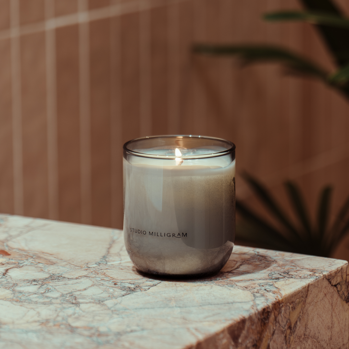 Studio Milligram Native Botanical Scented Candle 220g styled on a stone surface